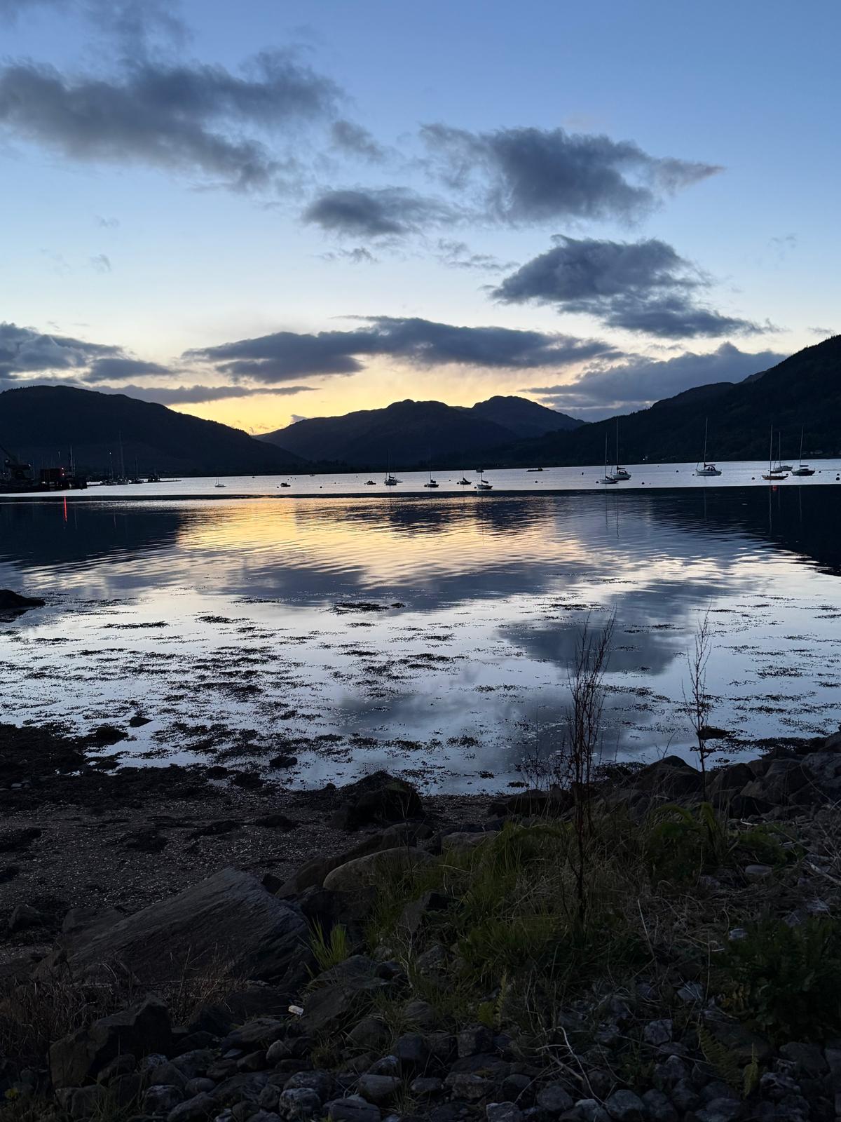 Twilight over the Holy Loch near Dunoon, with moored sailing boats and the Cowal hills silhouetted against the afterglow.